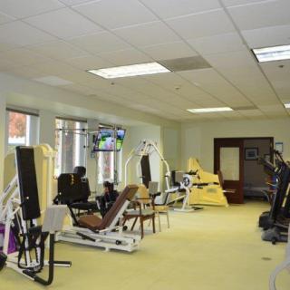 Interior view of a gym with various exercise equipment.