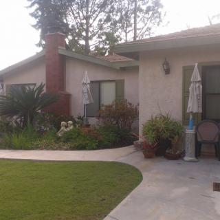 A suburban house with a well-maintained garden and patio area.