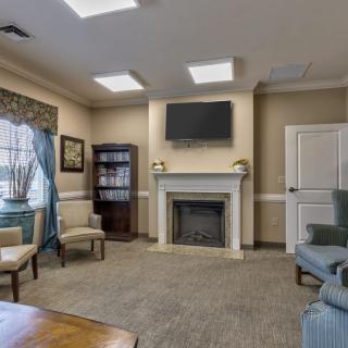 A cozy living room with a fireplace, TV, and comfortable seating.