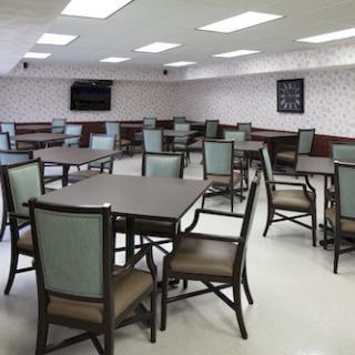 An empty dining area with multiple tables and chairs arranged neatly.