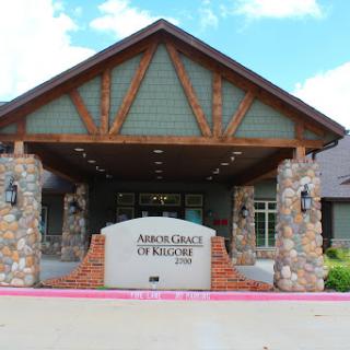 The entrance to a beautifully designed lodge featuring a combination of stone and wooden architecture.