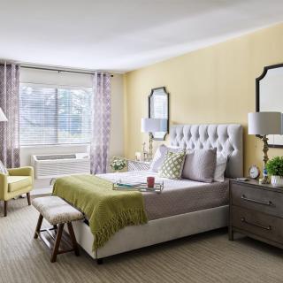 A modern bedroom with stylish decor and natural lighting.