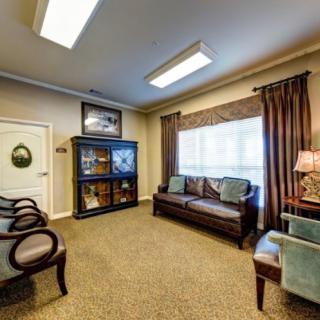 A cozy waiting room with comfortable seating and warm lighting.