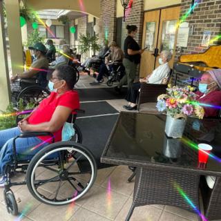 Residents enjoying a social moment in a communal space, emphasizing accessibility and connection.