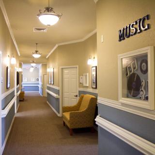 A well-lit hallway with music-themed artwork and comfortable seating.