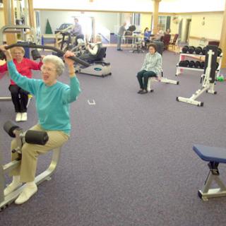 Seniors engaging in a group exercise session at a fitness center.