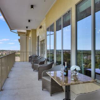 A spacious balcony with stylish furniture and a scenic view.