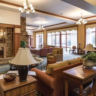 A cozy lobby interior with comfortable seating and decorative lighting.