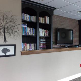 A cozy living room corner with a bookshelf and television.