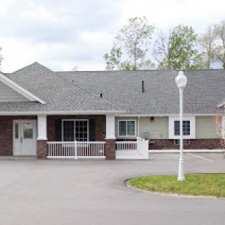 A charming single-story residential building with well-maintained landscaping.