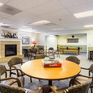 A cozy community lounge with a fireplace and seating area.