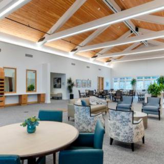 A modern and spacious lounge area featuring comfortable seating and natural lighting.