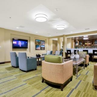 A modern lounge area with comfortable seating and a television.