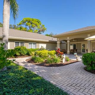 Beautiful home exterior with lush garden and patio.