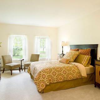 A cozy bedroom with elegant decor and natural lighting.