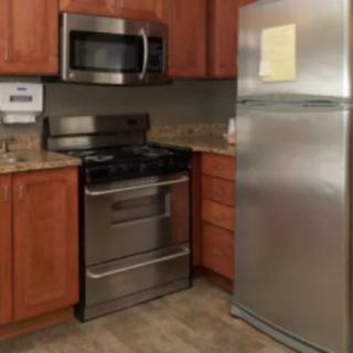 A modern kitchen featuring stainless steel appliances including a refrigerator, oven, and microwave.