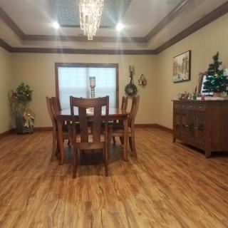 A well-decorated dining room with a wooden table and chandelier.