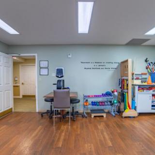 A rehabilitation therapy room equipped with medical and exercise tools.