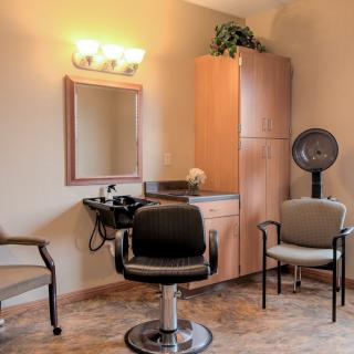 Interior of a hair salon with styling chairs and equipment.