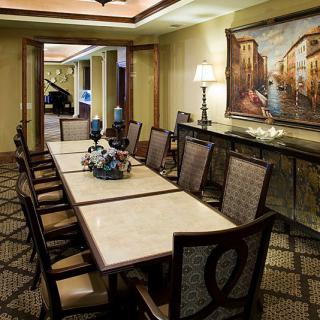 Elegant dining room with a long table and classic decor.