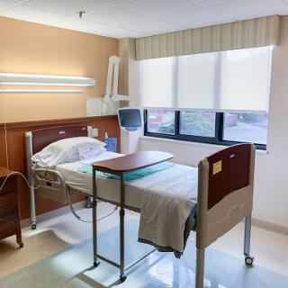 A clean and well-lit hospital patient room equipped with essential medical facilities.