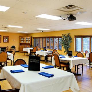 A cozy restaurant interior featuring neatly arranged tables and chairs, ready for guests.
