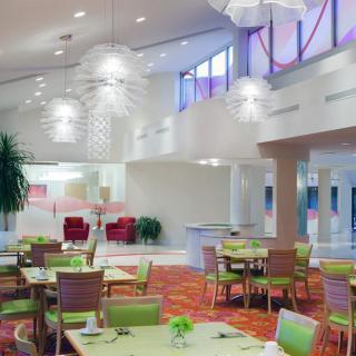 A modern restaurant interior with stylish lighting and contemporary furniture.
