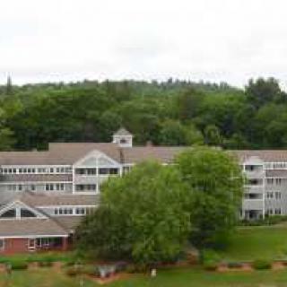 A large building surrounded by trees and greenery.