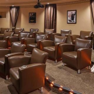 A luxurious movie theater with comfortable armchair seating and a cozy interior.