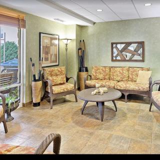 A cozy and well-decorated living room with comfortable seating and natural light.