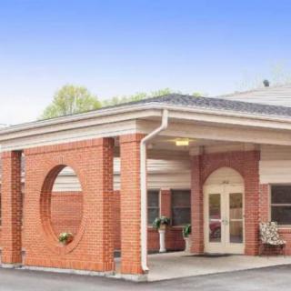 A brick building with a covered entrance and decorative circular cutouts.