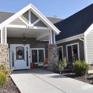 A modern residential house with a well-maintained front entrance and landscaping.