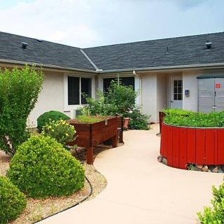 A tranquil courtyard garden with well-maintained bushes and a clear pathway.