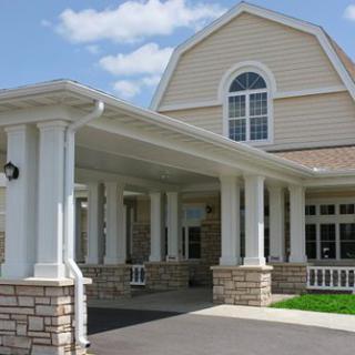 A residential building with a covered entrance and columns.