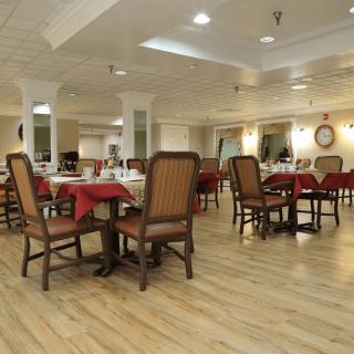 An empty, well-decorated dining area with neatly arranged tables and chairs.