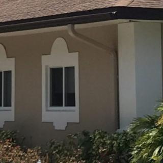 A view of a house exterior with distinctive window design.