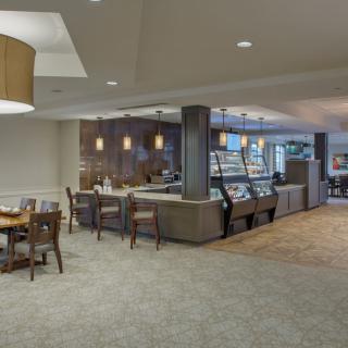 A cozy cafe interior with a seating area and counter service.