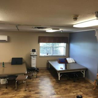 A therapy room with treatment beds and medical equipment.