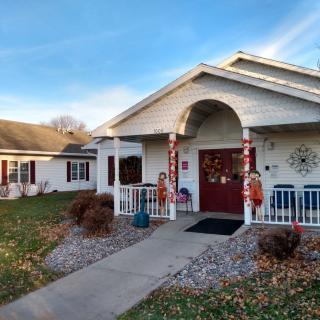 A charming house with a decorated front porch and a small garden.