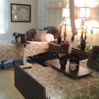 A well-furnished room with two beds and bedside lamps.