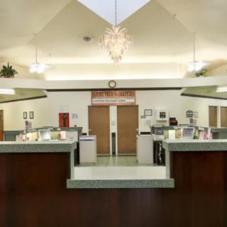 Modern reception area with a central desk and overhead lighting.