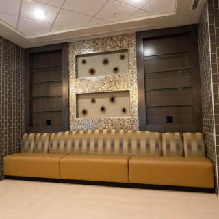 A modern lobby area featuring stylish seating and decorative wall elements.
