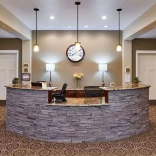 A hotel reception area with a stone desk and decorative lighting.