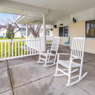 A cozy porch with two white rocking chairs, providing a tranquil outdoor space.