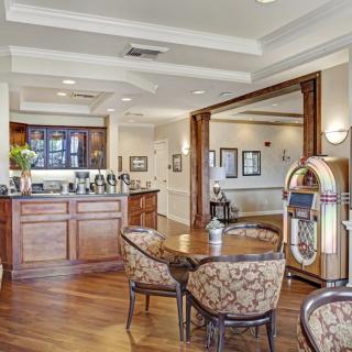 A cozy dining area featuring classic wooden furniture and a vintage jukebox.