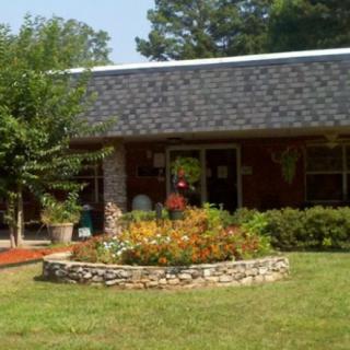 A cozy house with a well-maintained garden and lush greenery.