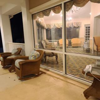 A cozy living room view with comfortable seating and soft evening light filtering through the glass doors.