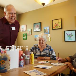 Elderly individuals participating in an art class together.