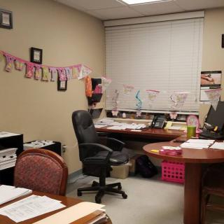 A neatly organized office space with decorations and a computer desk.