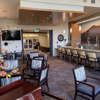 An empty lounge and bar area with modern decor and comfortable seating.